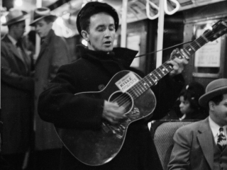 Woody Guthrie singing aboard a New York City subway train