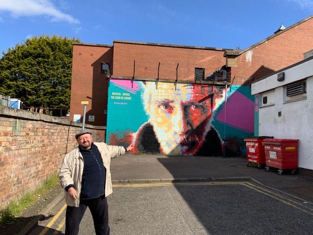 Dai Woosnam at the Michael Marra mural in Lochee, Dundee, May 2022